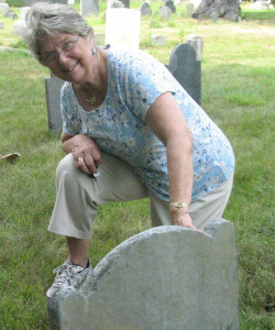 Woman cleaning gravestone