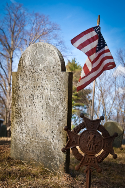 Old gravestone with American flag